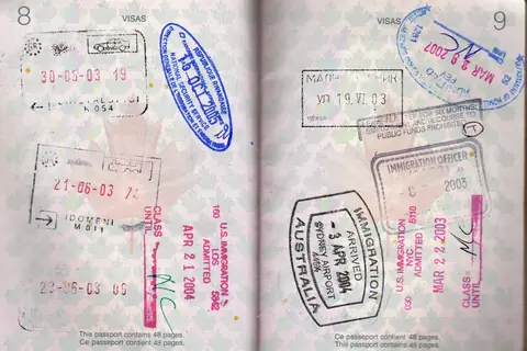 Two pages of a Canadian passport filled with entry stamps