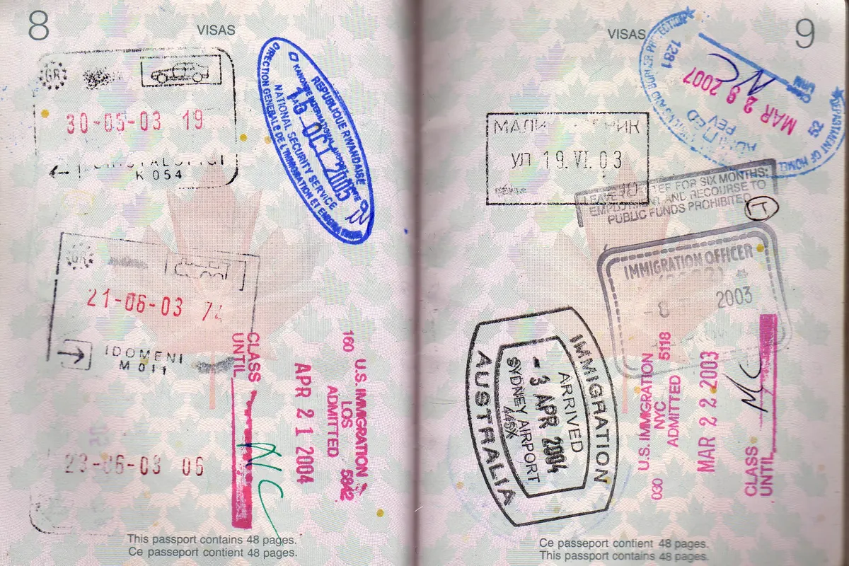 Two pages of a Canadian passport filled with entry stamps