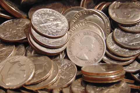 A 1953 Canadian dime among a pile of US dimes