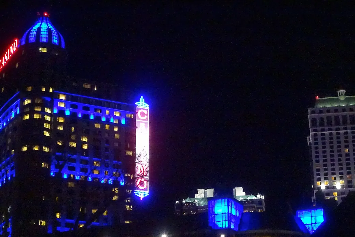 Niagara Falls casino tower lit in blue at night