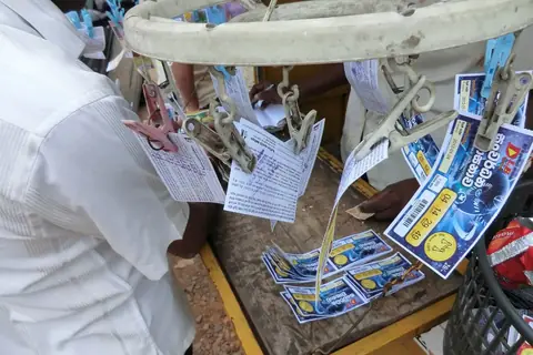 Lottery tickets clipped on a vendor’s stand at a street stall