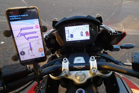 Phone with a navigation map mounted on motorcycle handlebars
