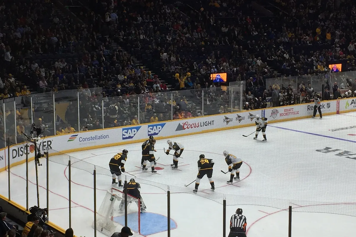 NHL All-Star Game face-off seen from the stands of a full arena